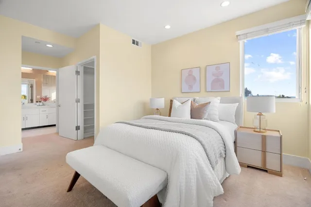 a bedroom with a bed and a painting on the wall