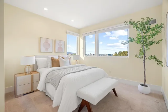 a spacious bedroom with a bed and a large window