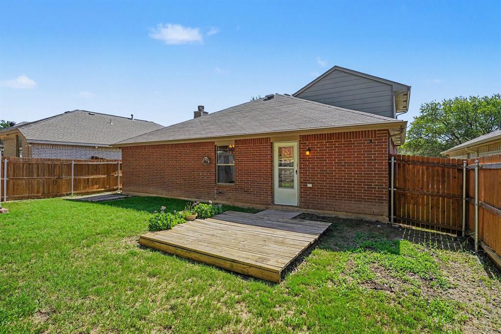 2541 Rivers Edge Drive Fort Worth, TX 76118 - Photo 29 of 31 a backyard of a house with wooden fence and a large tree