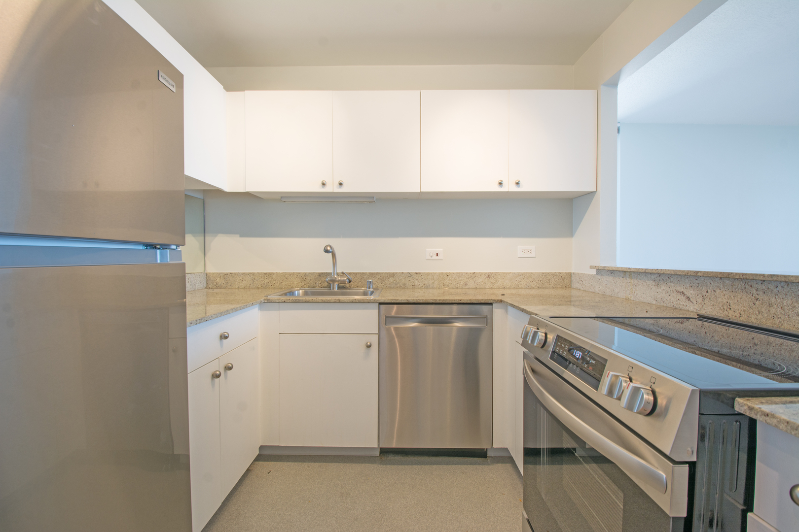 3660 North Lake Shore Drive, Unit 3910 Chicago, IL 60613 - Photo 14 of 25 a utility room with granite countertop cabinets washer and dryer