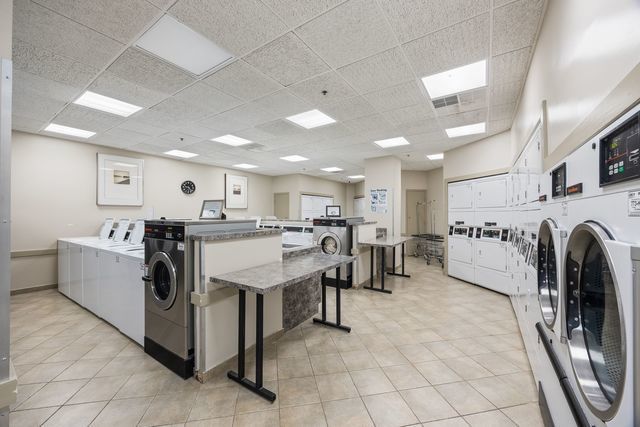 3660 North Lake Shore Drive, Unit 3910 Chicago, IL 60613 - Photo 25 of 25 a living room with stainless steel appliances kitchen island granite countertop lots of white furniture and a view of living room