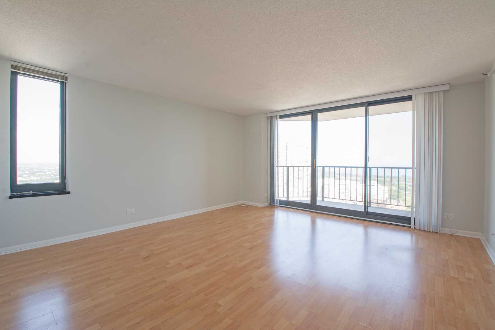 3660 North Lake Shore Drive, Unit 3910 Chicago, IL 60613 - Photo 8 of 25 a view of an empty room with wooden floor and a window
