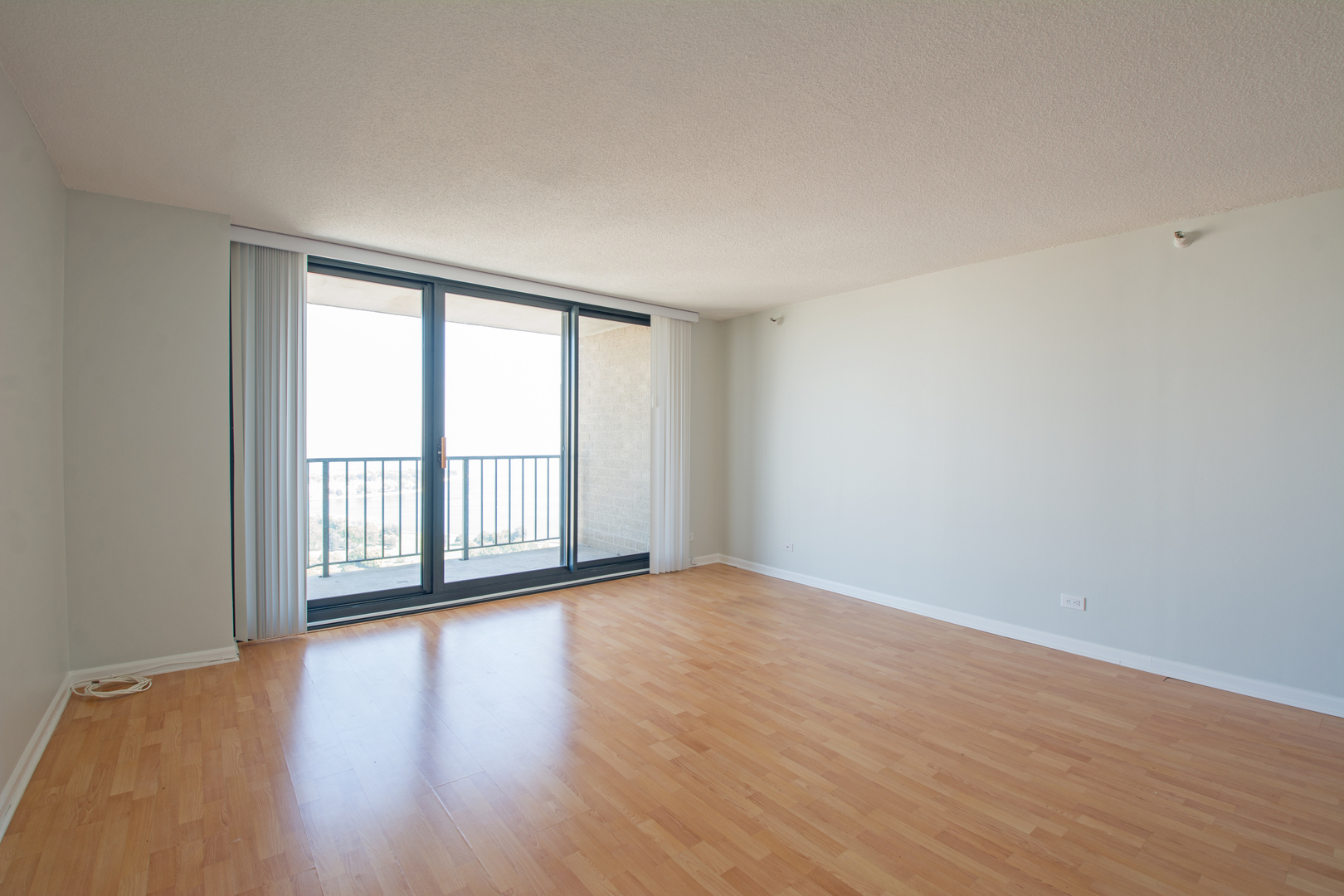 3660 North Lake Shore Drive, Unit 3910 Chicago, IL 60613 - Photo 9 of 25 a view of an empty room with wooden floor and a window