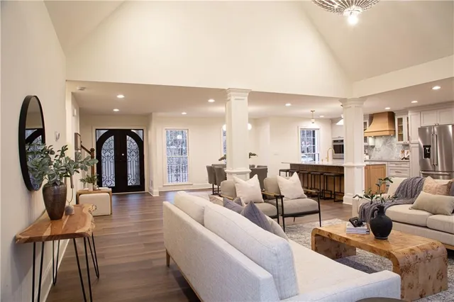 a living room with furniture and a chandelier