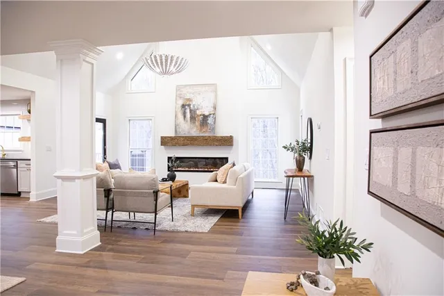a living room with furniture a fireplace and a potted plant