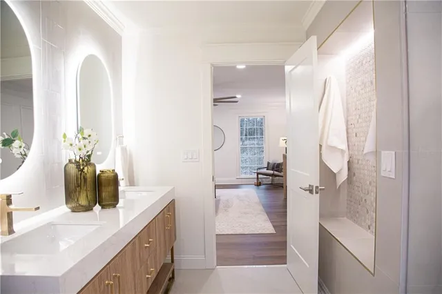 a bathroom with a double vanity sink and a mirror