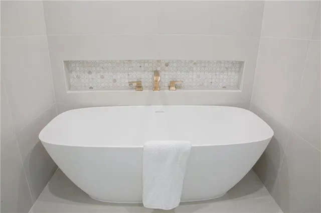a bathroom with a bath tub with a shower