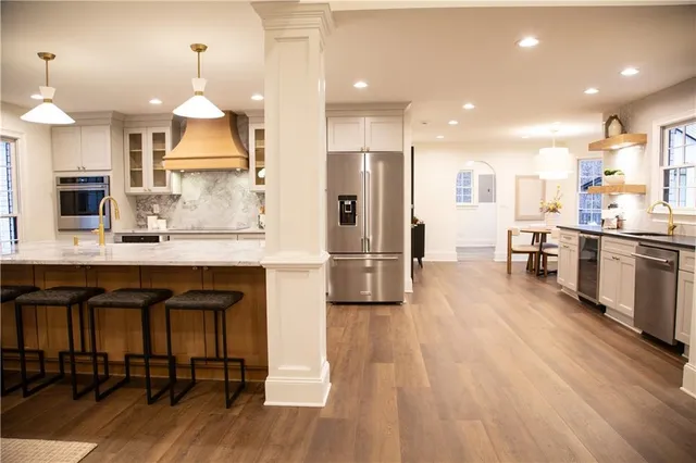 a dining room with furniture and wooden floor