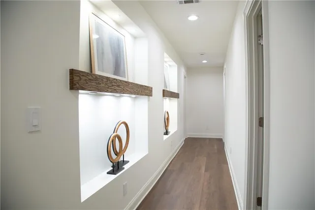 a dining room with furniture and wooden floor