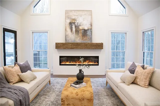 a living room with furniture and a fireplace