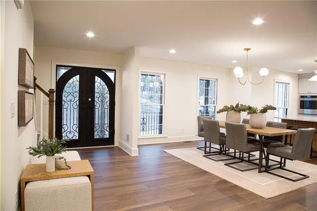 a living room with furniture a window and wooden floor