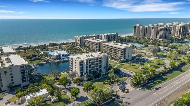 a view of swimming pool with outdoor seating and lake view