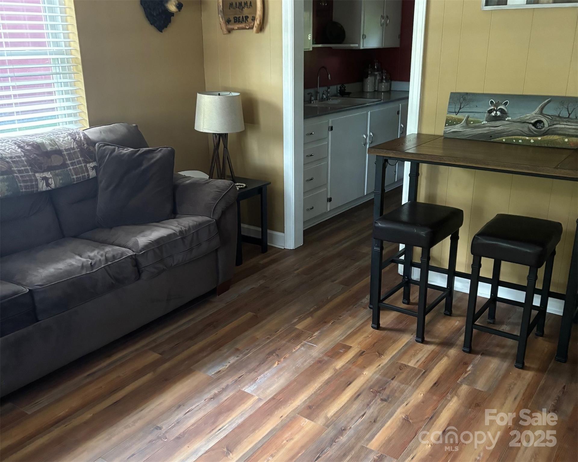 1555 Soco Road, Unit 12 Maggie Valley, NC 28751 - Photo 12 of 12 a living room with furniture and a wooden floor