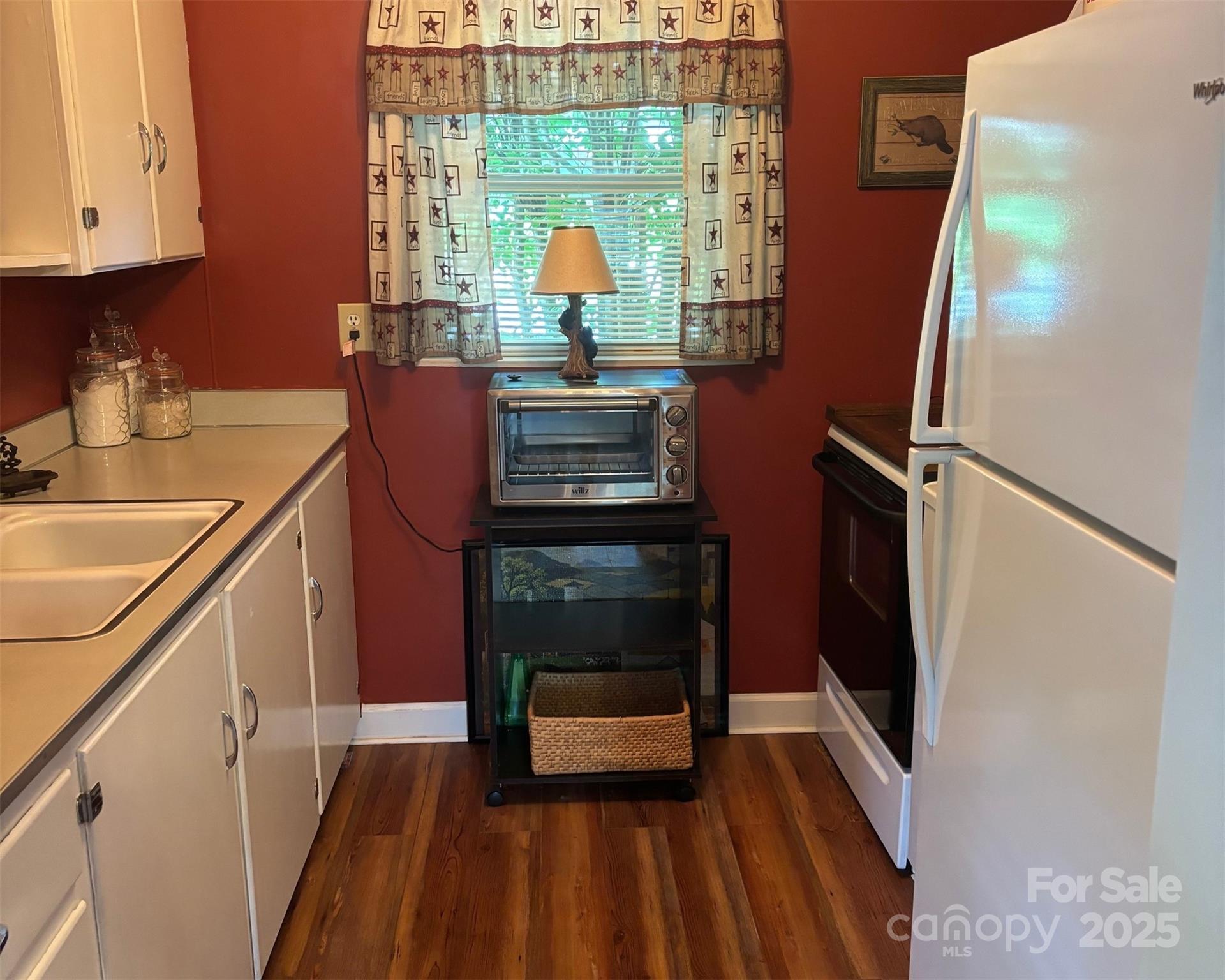 1555 Soco Road, Unit 12 Maggie Valley, NC 28751 - Photo 2 of 12 a kitchen with a sink appliances and cabinets