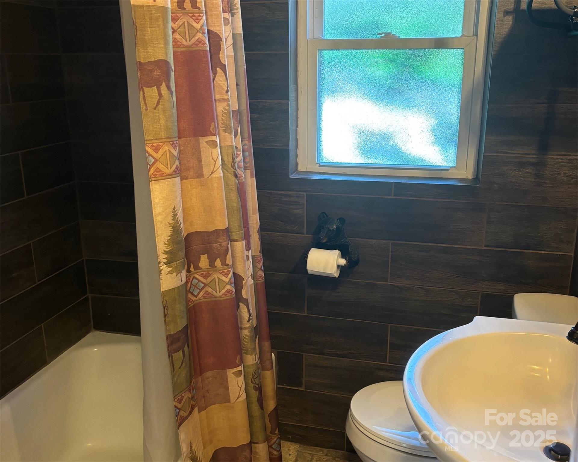 1555 Soco Road, Unit 12 Maggie Valley, NC 28751 - Photo 6 of 12 a bathroom with a toilet and a shower