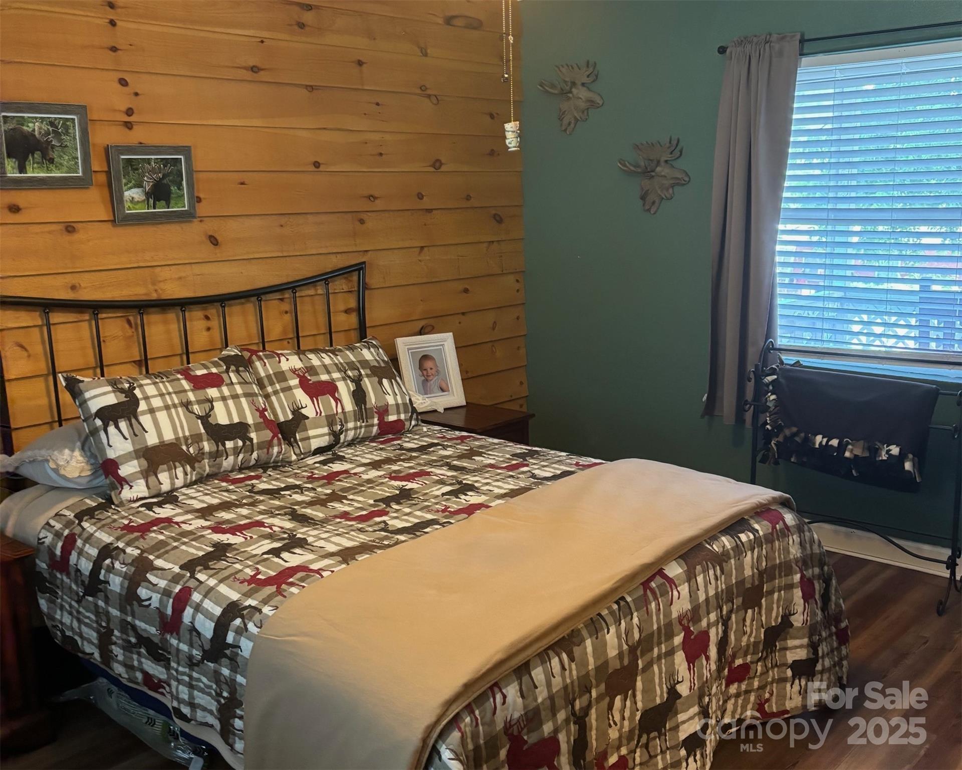 1555 Soco Road, Unit 12 Maggie Valley, NC 28751 - Photo 9 of 12 a bed sitting in a bedroom next to a window