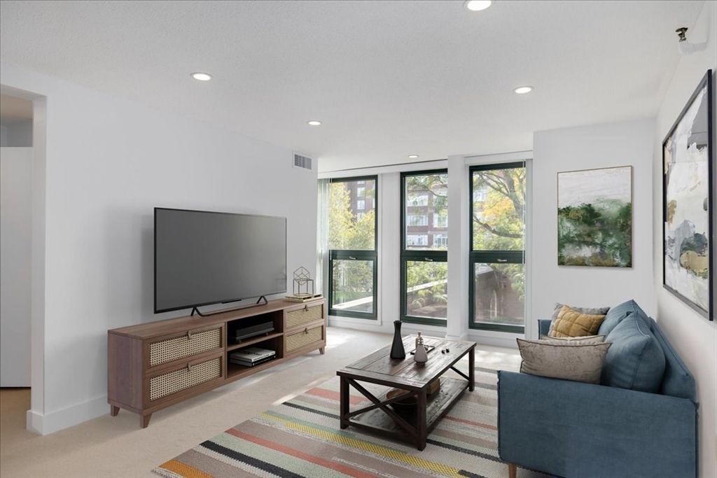 42 8th Street, Unit 5316 Boston, MA 02129 - Photo 2 of 39 a living room with furniture and a flat screen tv
