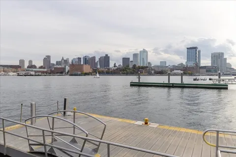 a swimming pool with outdoor seating and a bench