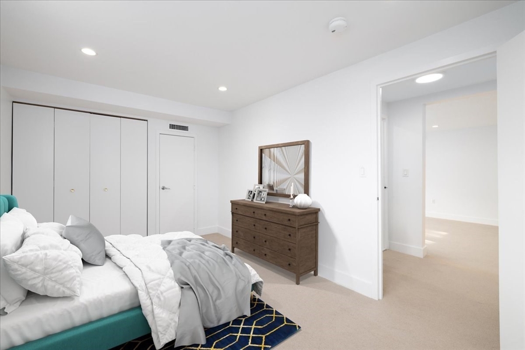 42 8th Street, Unit 5316 Boston, MA 02129 - Photo 7 of 39 a bedroom with a bed and wooden floor