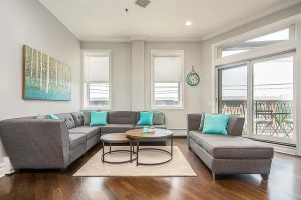 a living room with furniture and a large window