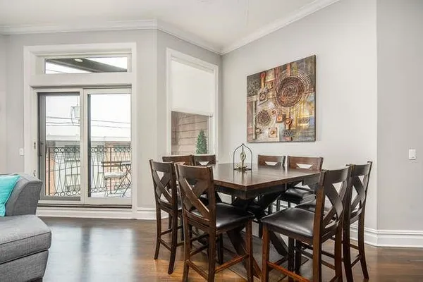 a view of a dining room with furniture wooden floor and a window