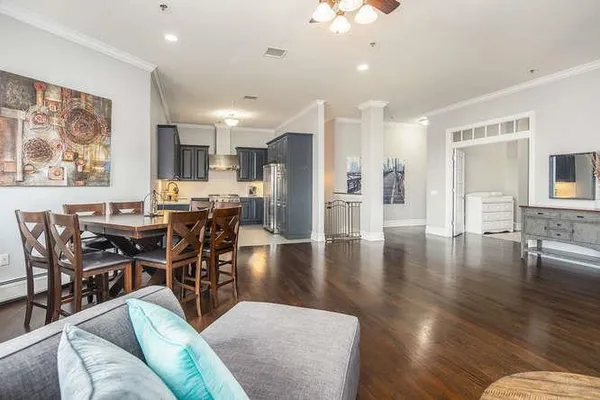 a living room with furniture and wooden floor