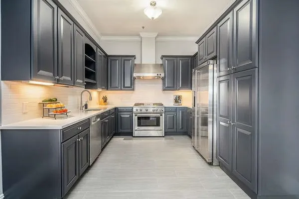 a kitchen with stainless steel appliances granite countertop a stove top oven a sink and dishwasher