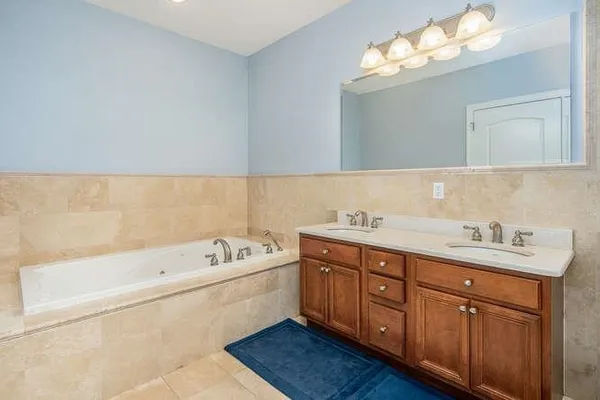 a bedroom with a white bed and white cabinets