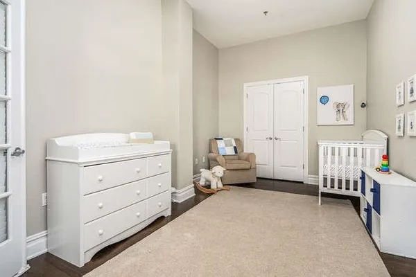 a view of a bedroom with furniture and window