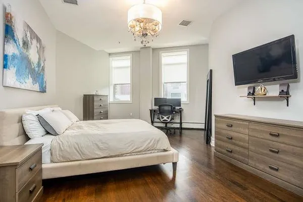 a bedroom with a bed and a flat screen tv