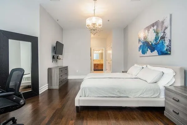 a bedroom with a bed and a chandelier