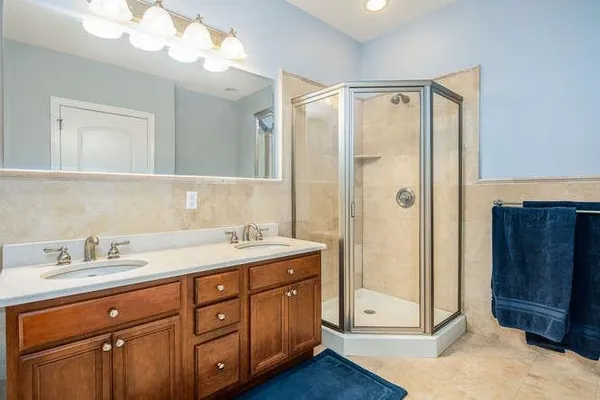 a bathroom with a shower sink and mirror