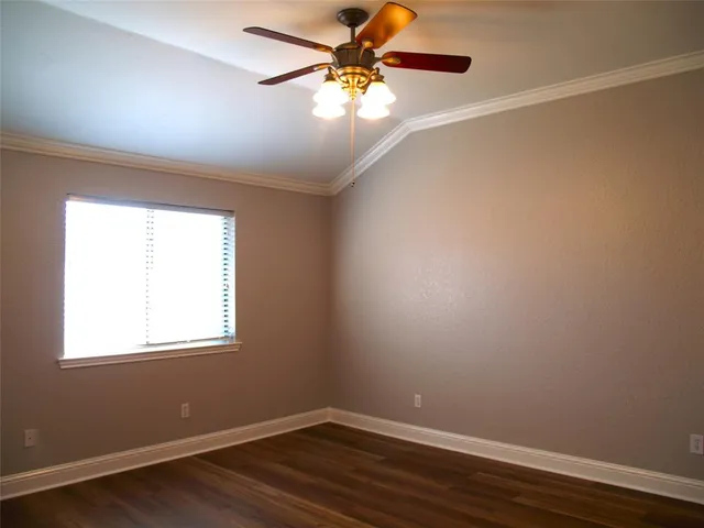 a view of a room with wooden floor and a window