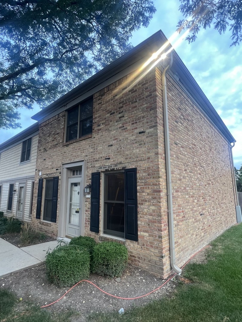 a brick house with a large windows