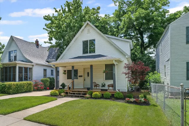 a view of a chair and table in backyard of the house