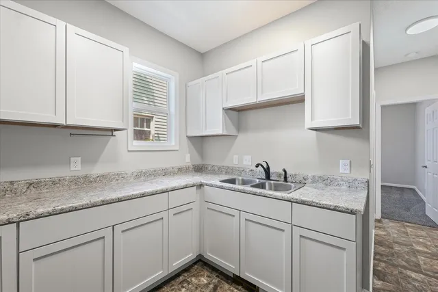a kitchen with a sink dishwasher and cabinets