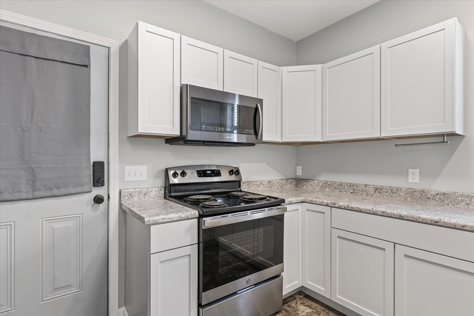 1391 West Decatur Street Decatur, IL 62522 - Photo 12 of 28 a kitchen with white cabinets and white appliances