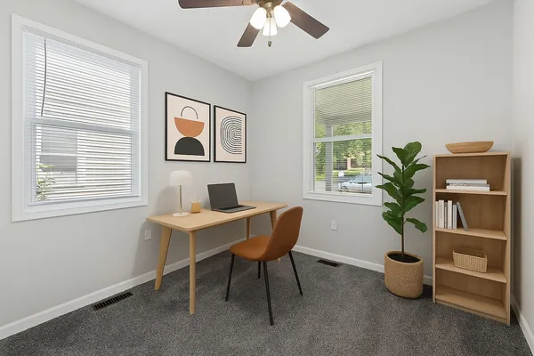 a work room with furniture and potted plant