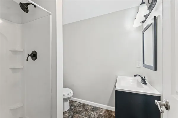 a bathroom with a sink toilet and shower