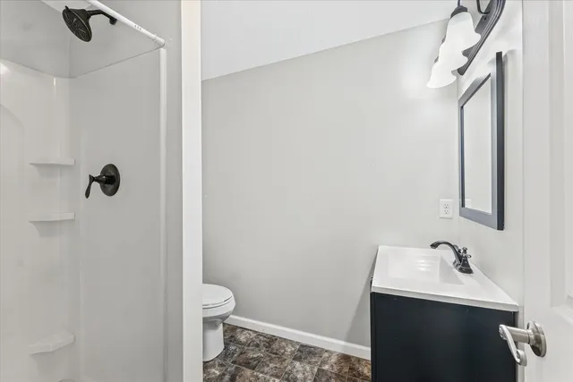 a bathroom with a sink toilet and shower