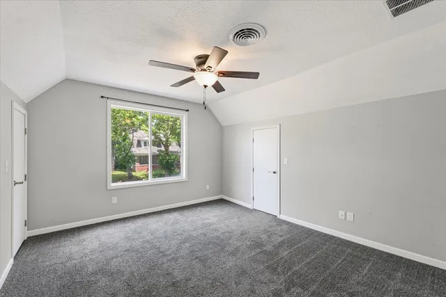 a view of room with a ceiling fan and a window