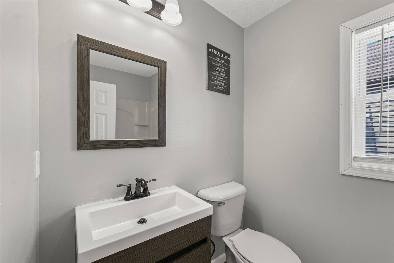 1391 West Decatur Street Decatur, IL 62522 - Photo 23 of 28 a bathroom with a toilet sink and mirror