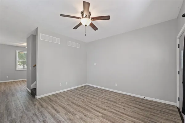 wooden floor in an empty room with a window