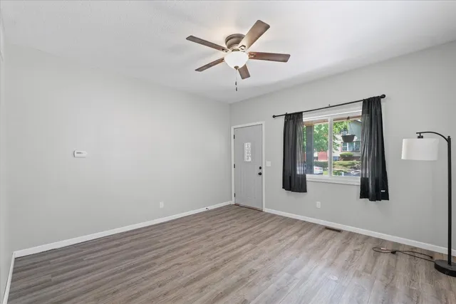 wooden floor in an empty room with a window