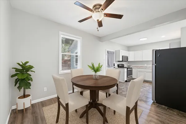a view of a dining room with furniture window and wooden floor
