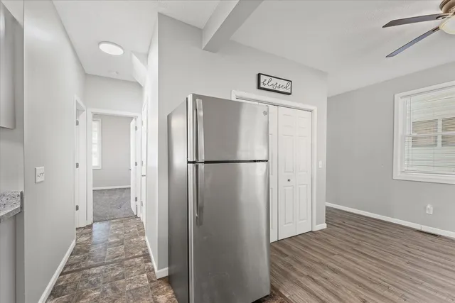 a view of a refrigerator in kitchen and wooden floor