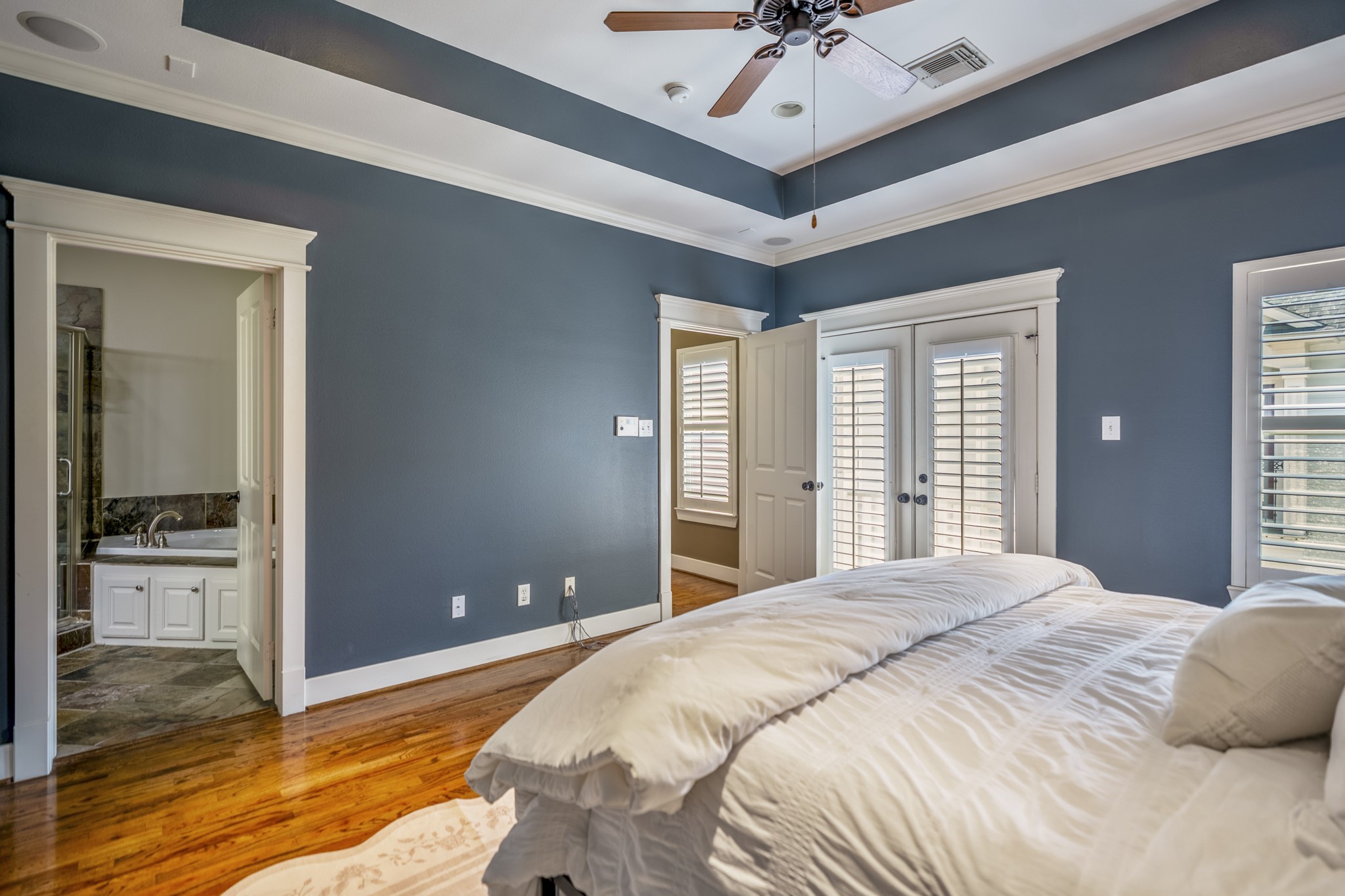 905 West 23rd Street Houston, TX 77008 - Photo 33 of 46 Spacious primary retreat featuring tray ceilings and French doors opening to a private balcony.