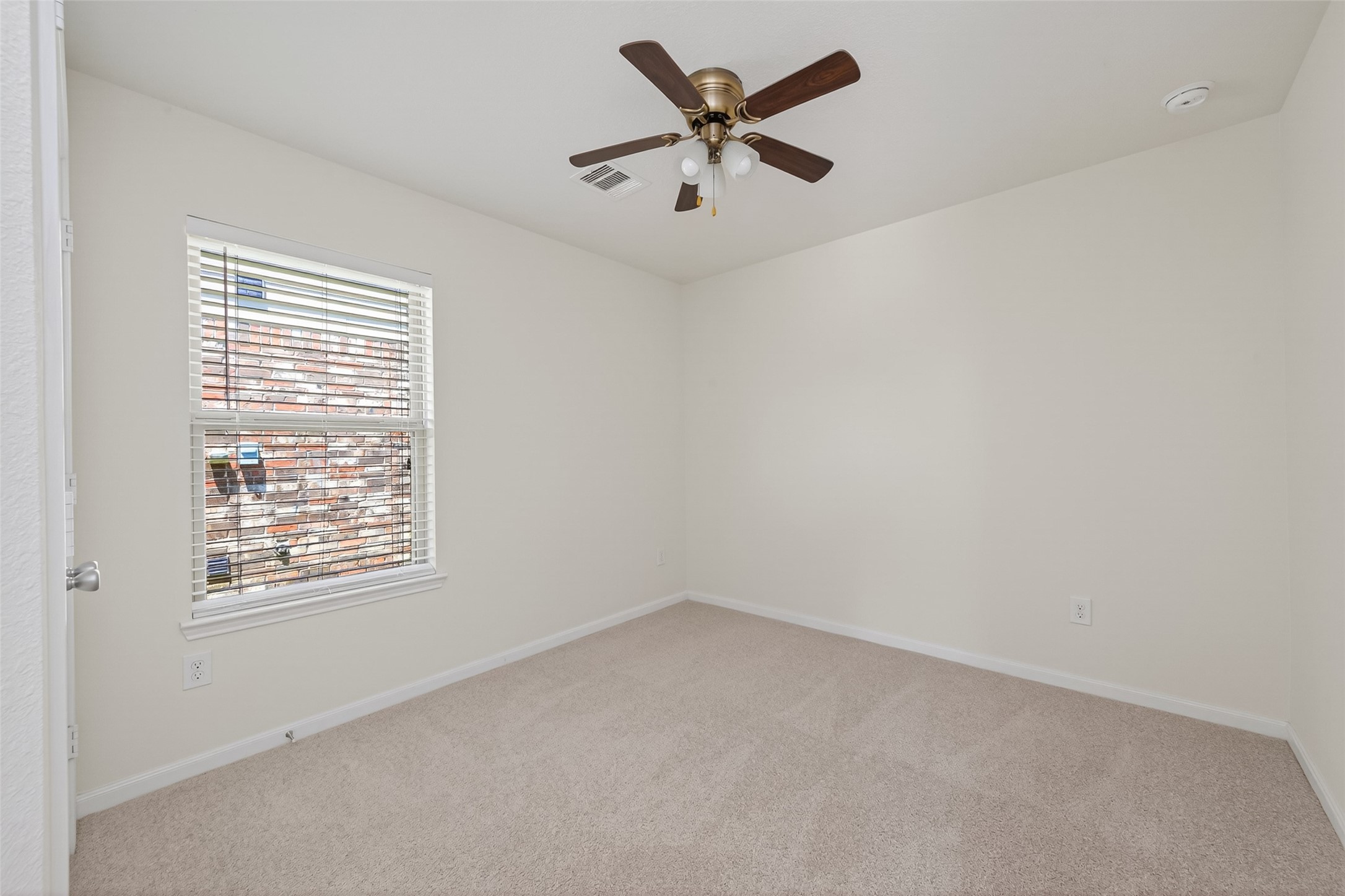 2754 Cayden Creek Way Conroe, TX 77304 - Photo 19 of 40 an empty room with a window and a ceiling fan