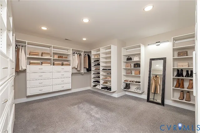 a view of an empty room with furniture and storage
