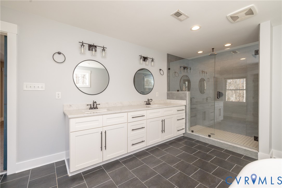 2744 Dogtown Road Goochland, VA 23063 - Photo 27 of 46 a bathroom with a double vanity sink mirror and shower